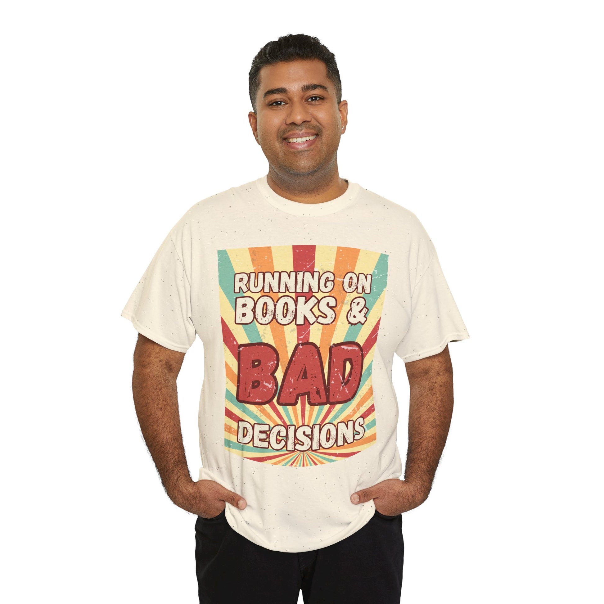 Man wearing a beige t-shirt with colorful retro burst strip graphic and text 'Running on Books & Bad Decisions' 