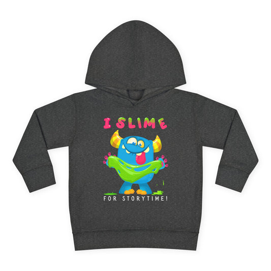 Blue cartoon monster playing with bright green slime while holding a book, with the words “I Slime for Storytime” above — printed on a toddler hoodie.