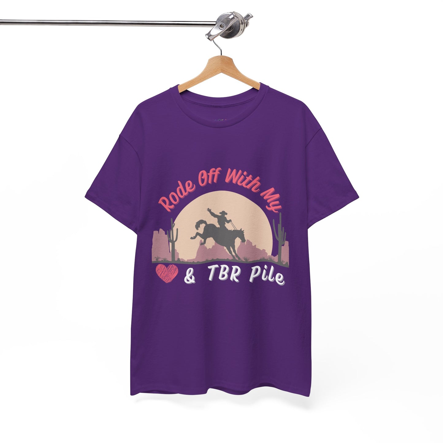 Purple t-shirt with soft dessert sunset and a cowboy on a horse, text 'Rode Off With My Heart & TBR Pile'