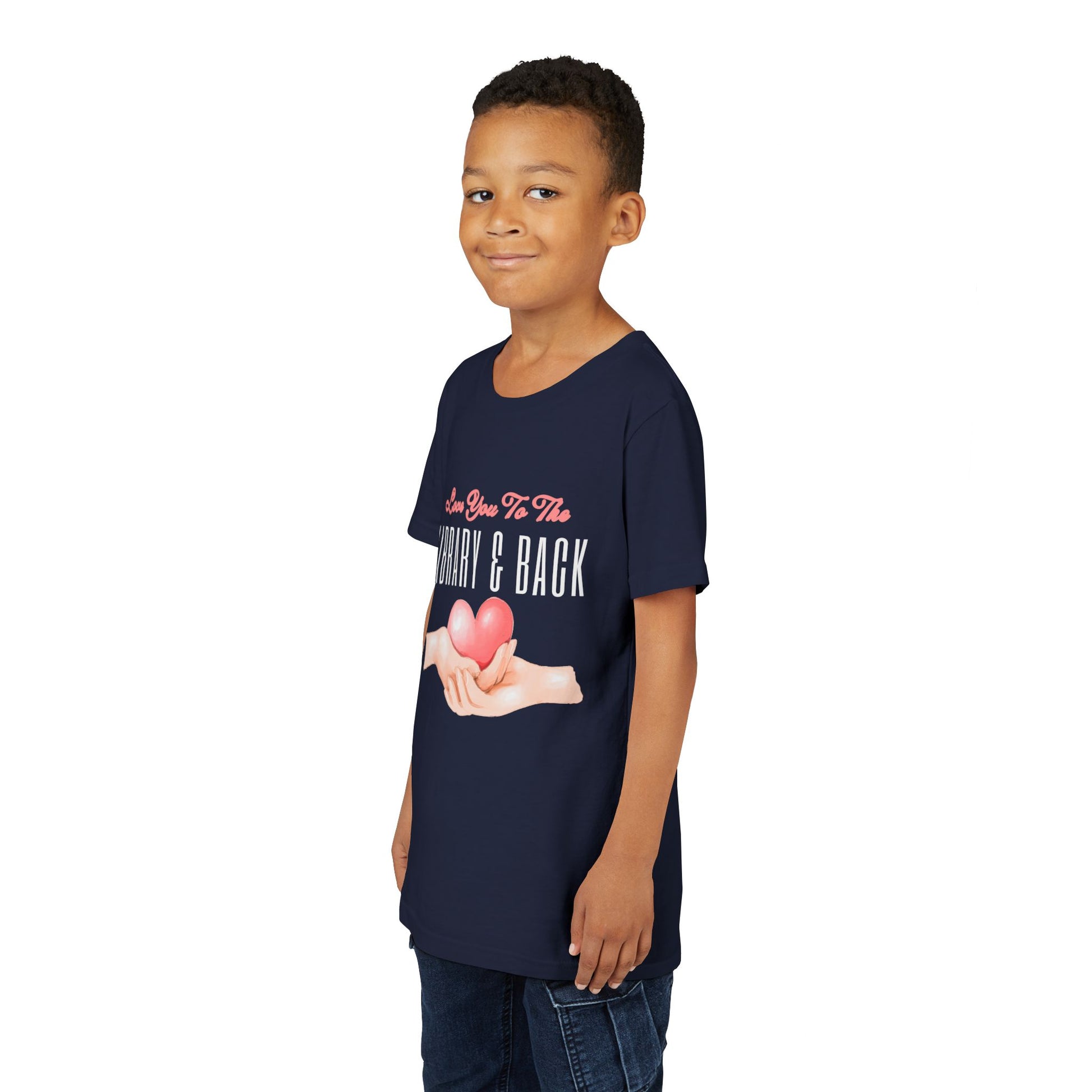 Boy wearing a navy blue t-shirt with a graphic of hands holding a heart and text 'Love You To The Library & Back' 
