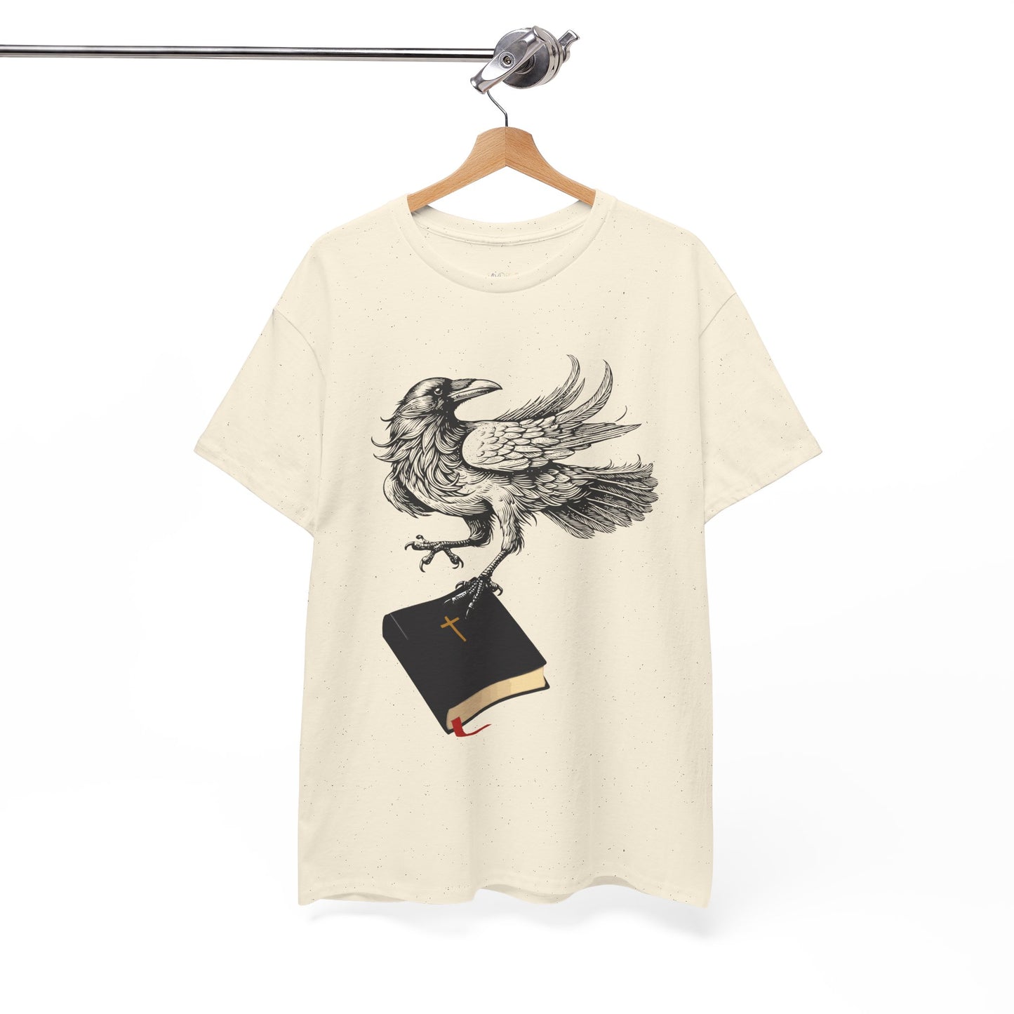 Beige t-shirt with a crow carying a bible, a shirt on a hanger against a white background