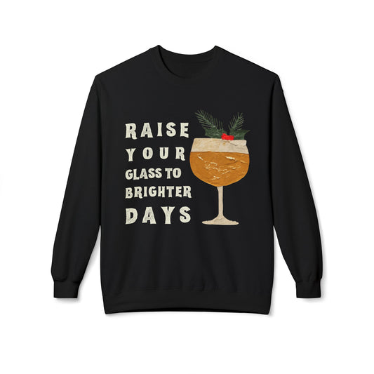 Black sweatshirt with a festive drink graphic and text 'raise your glass to brighter days' on a white background