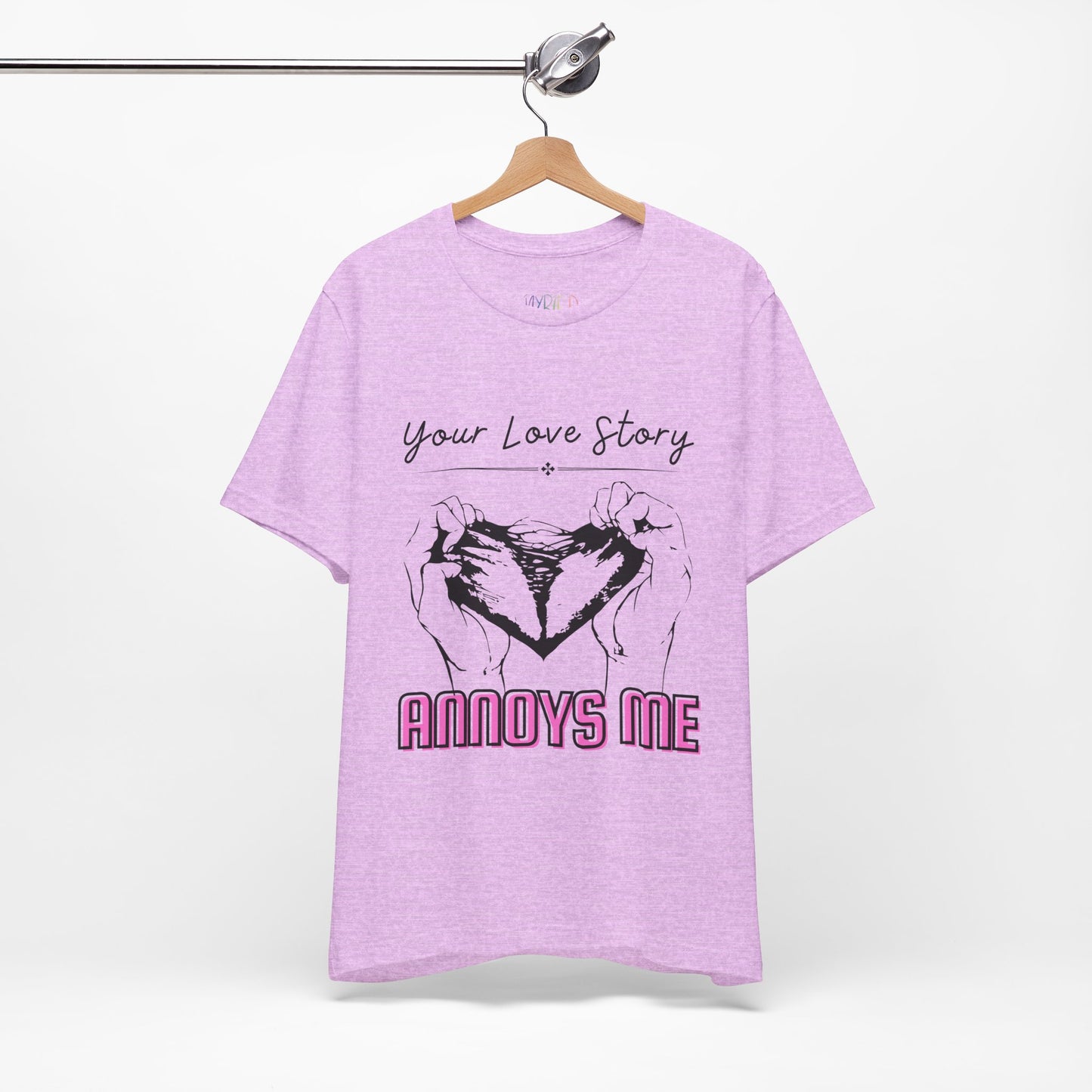 Light purple  t-shirt with graphic design of two hands pulling apart a heart and text 'Your Love Story ANNOYS ME'