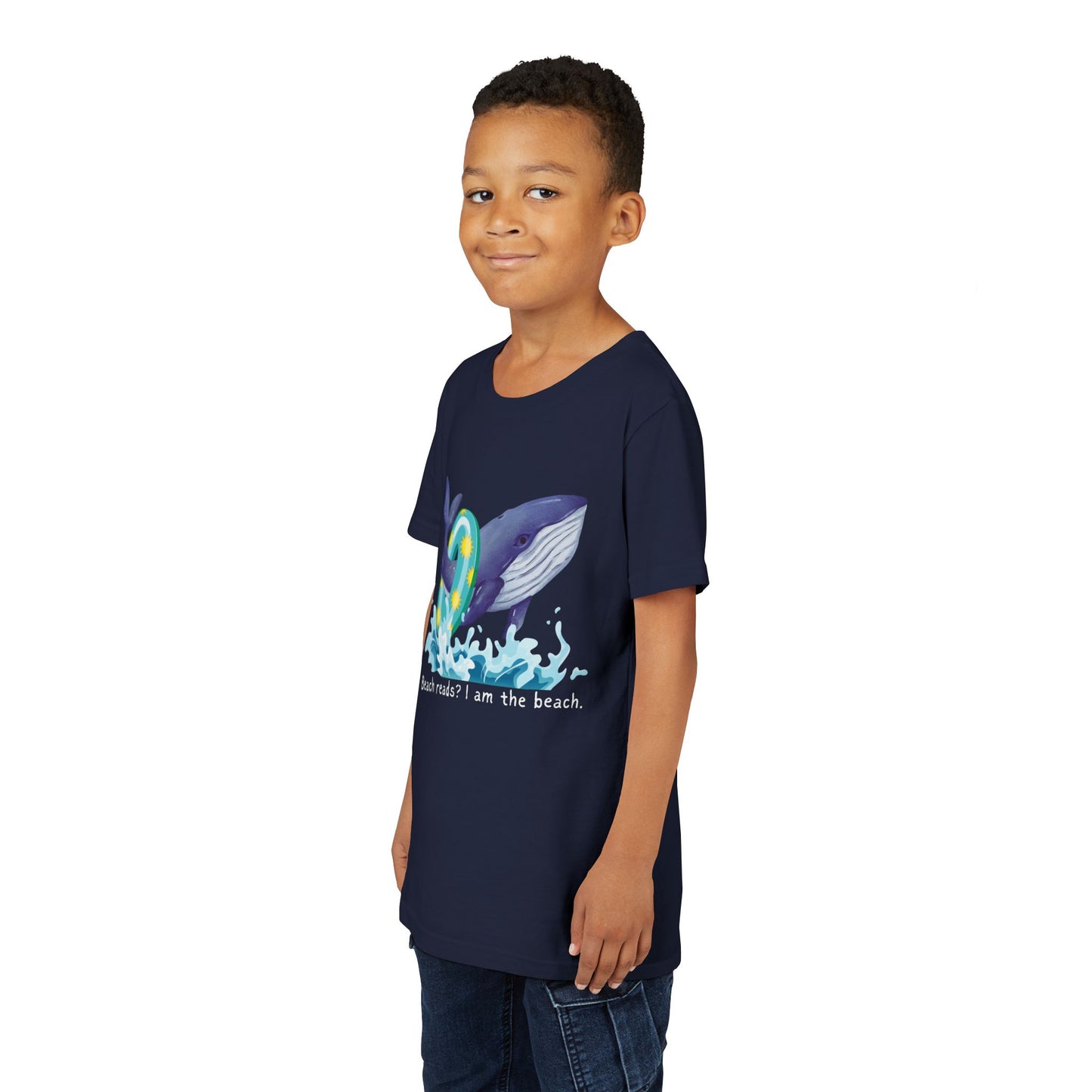 Boy wearing a navy blue t-shirt with a whale wearing a pool floaty ring and text 'Beach reads? I am the beach.'