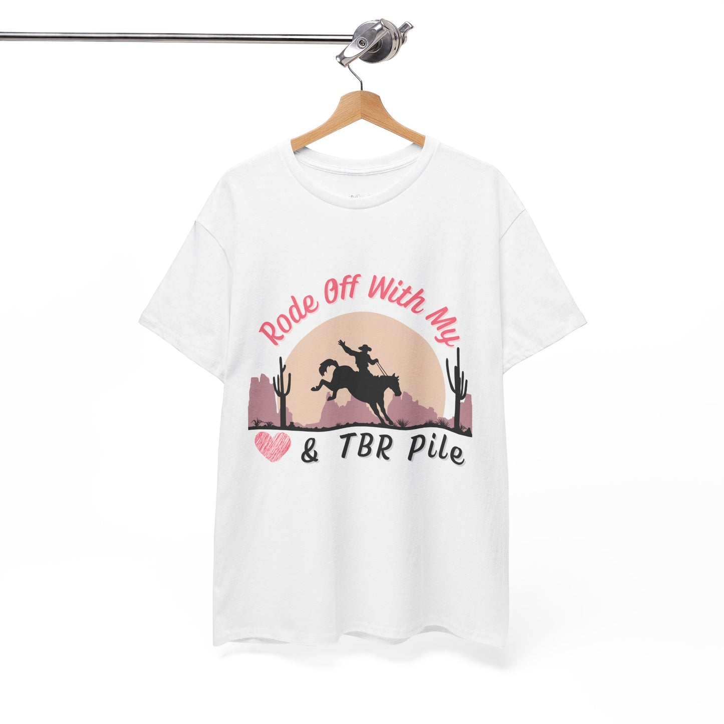 White t-shirt with soft dessert sunset and a cowboy on a horse, text 'Rode Off With My Heart & TBR Pile'