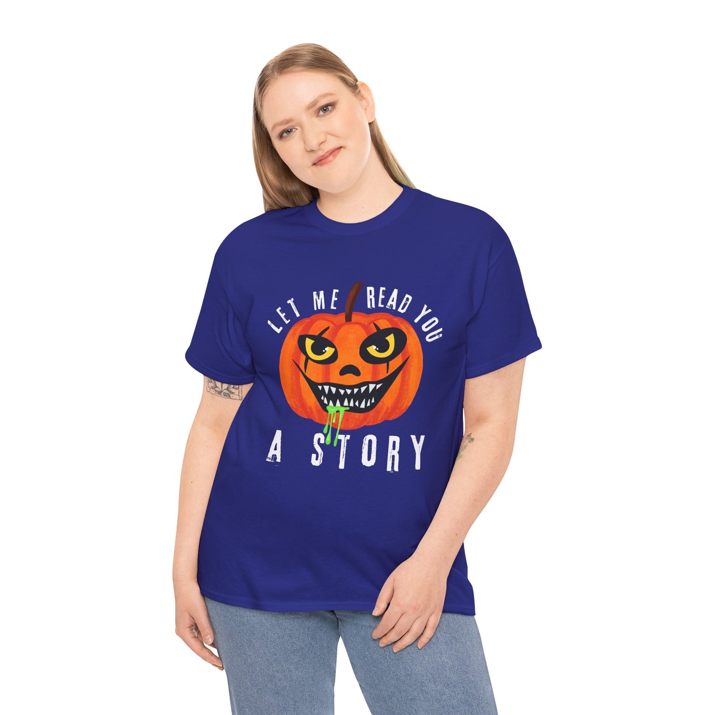 Woman wearing a blue t-shirt with an evil pumpkin graphic and text 'Let Me Read You A Story' on a hanger against a white background