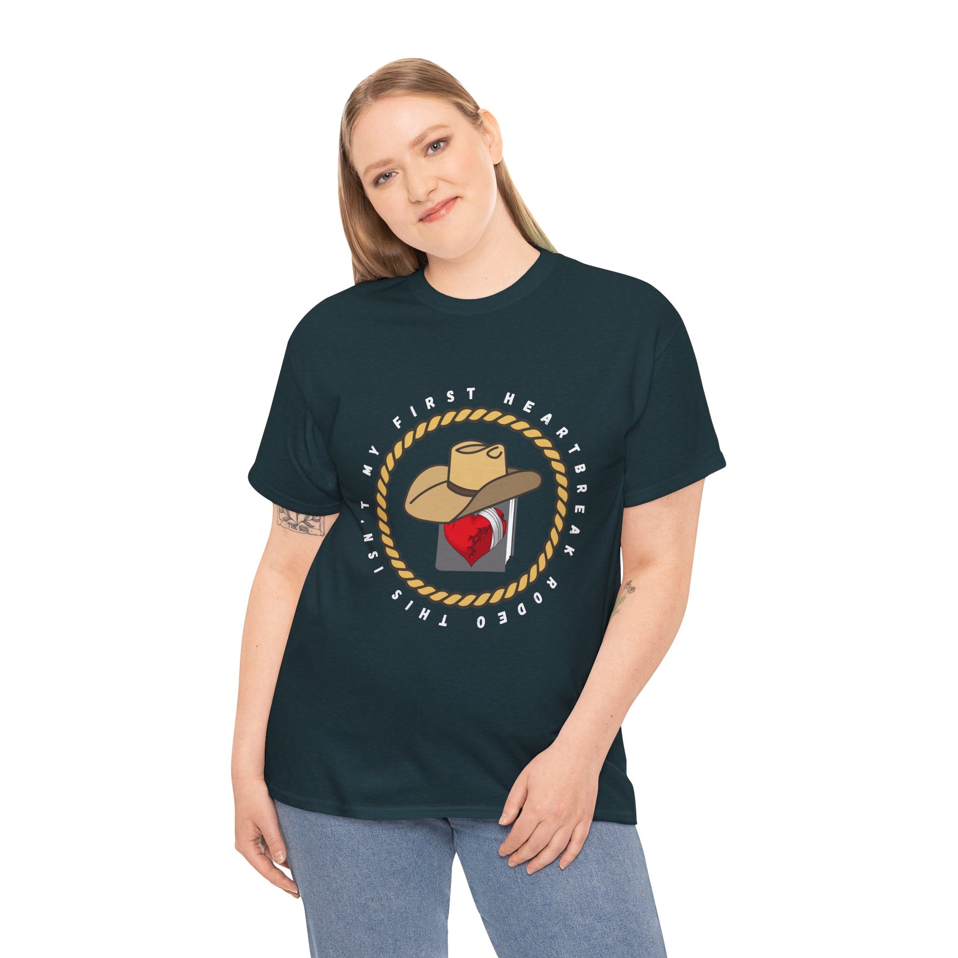 Woman wearing a dark t-shirt with a cowboy hat atop a book with a broken heart, circled by a rope and text 'This Isn't My First Heartbreak Rodeo'