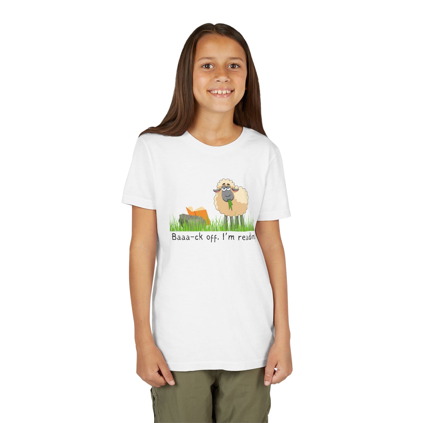 Girl wearing a white t-shirt with a sheep graphic reading a book and text 'Baaa-ck off, I'm reading!'