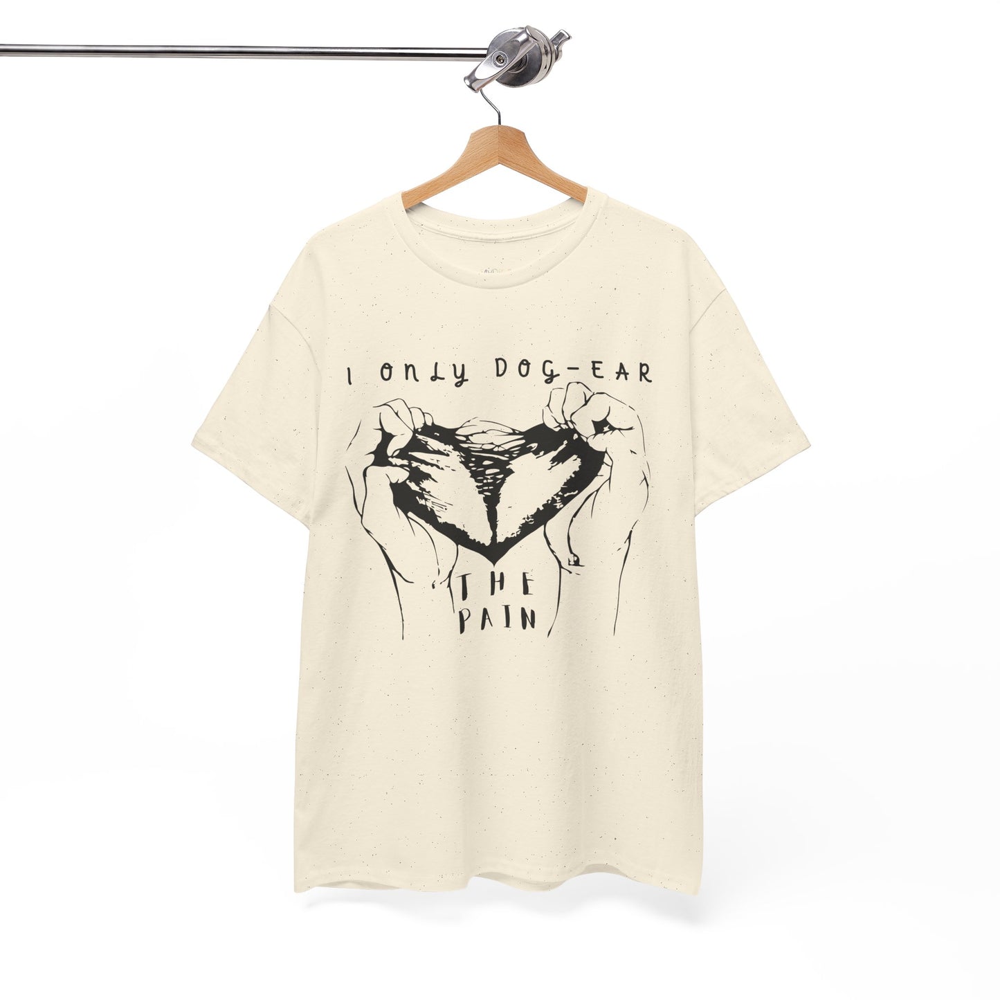 Beige t-shirt with black graphic of hands tearing apart a heart and text 'I Only Dog-Ear The Pain'