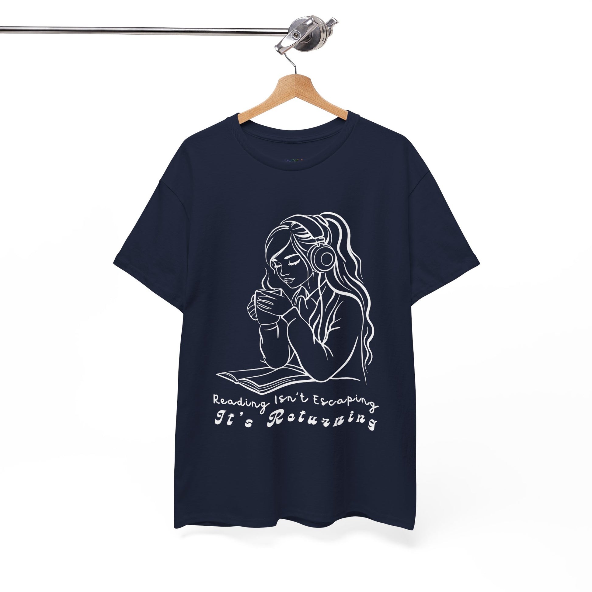 Navy blue t-shirt with a woman wearing headphones, cupping a hot beverage and reading a book, text 'Reading Isn't Escaping, It's Returning'