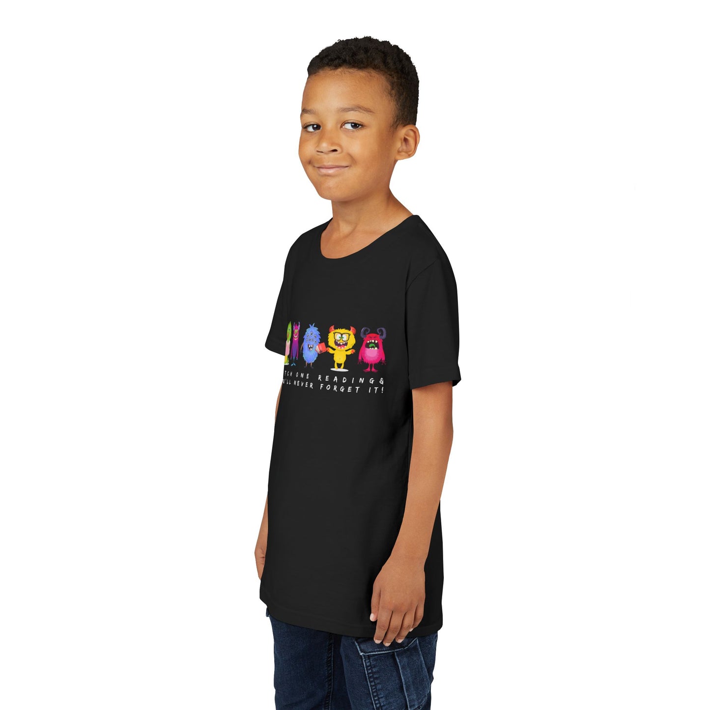 Boy wearing a black t-shirt with a row of colorful cartoon monster characters and text 'Catch One Reading & You'll Never Forget It'