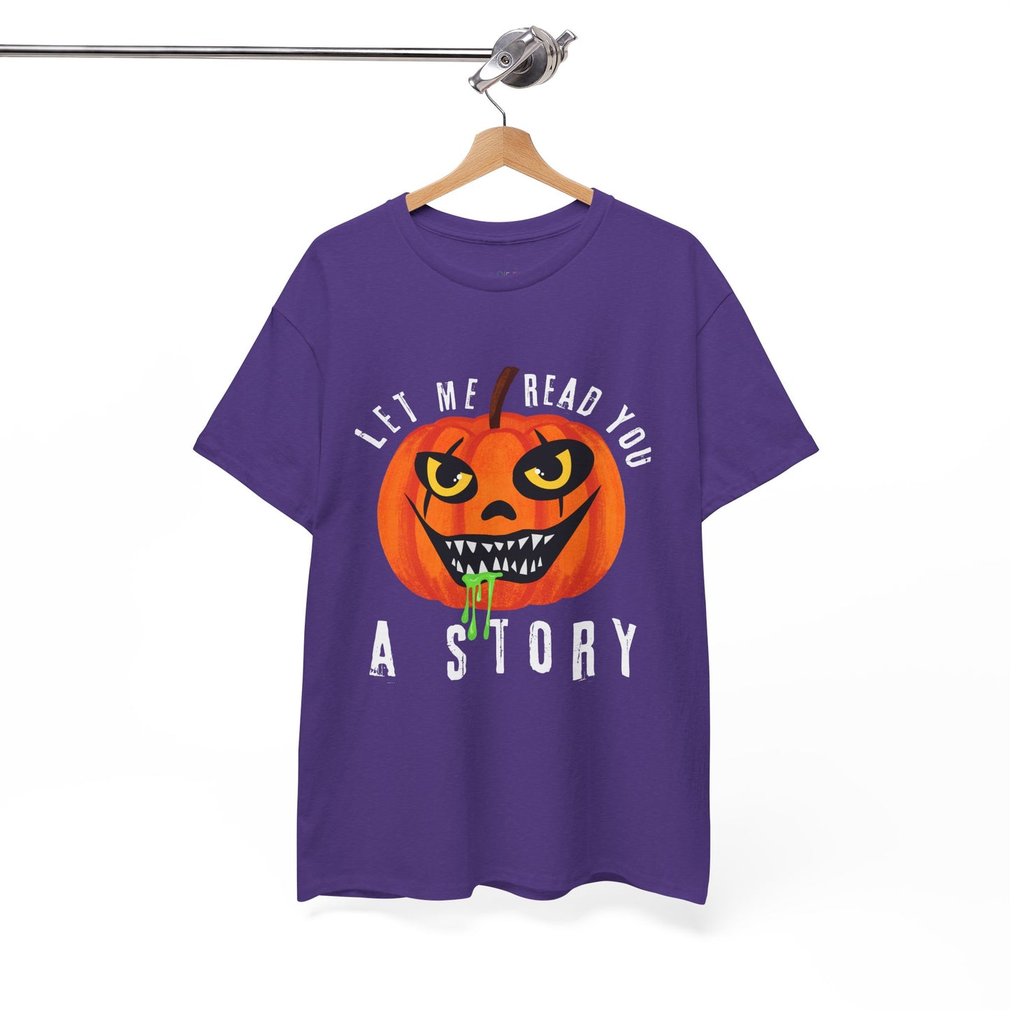 Purple t-shirt with an evil pumpkin graphic and text 'Let Me Read You A Story' on a hanger against a white background
