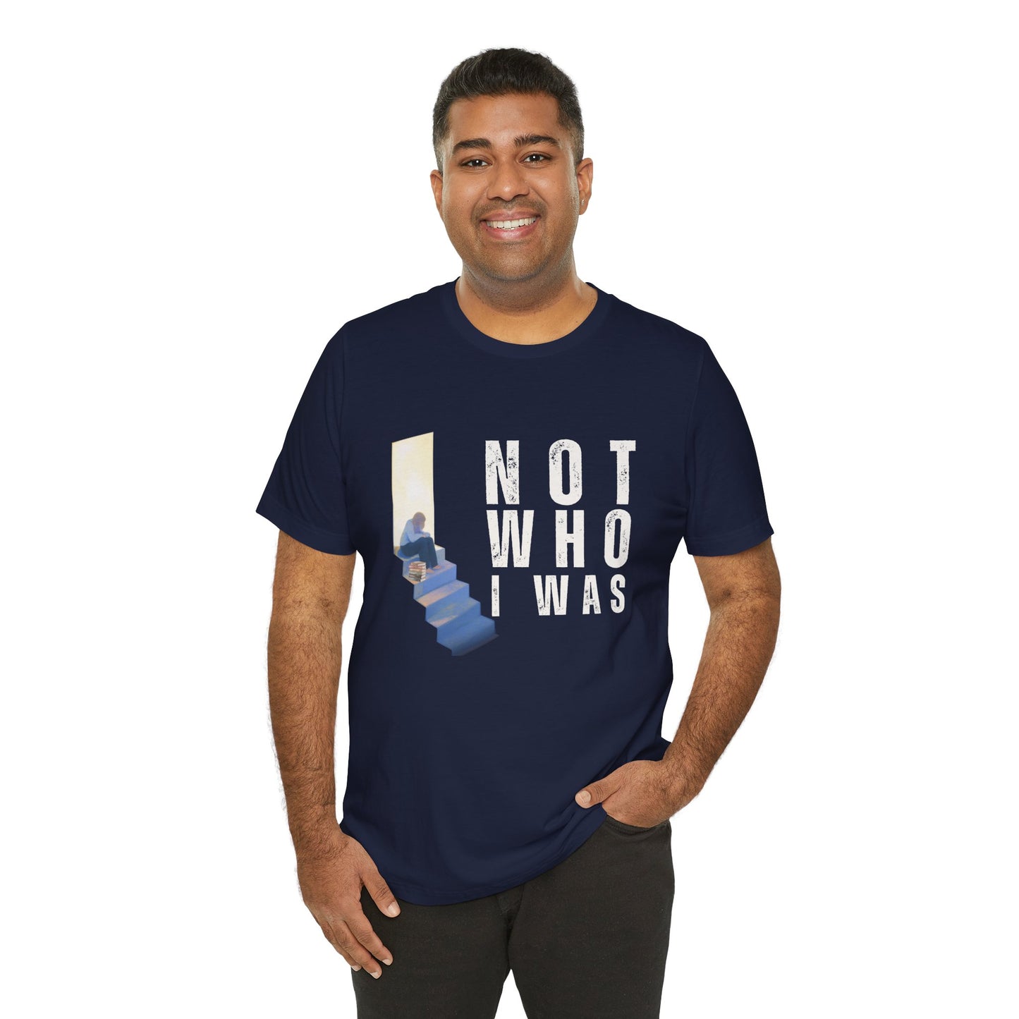 Man wearing a navy blue t-shirt with person sitting at the top of the stairs, lit from behind and text 'Not Who I Was'