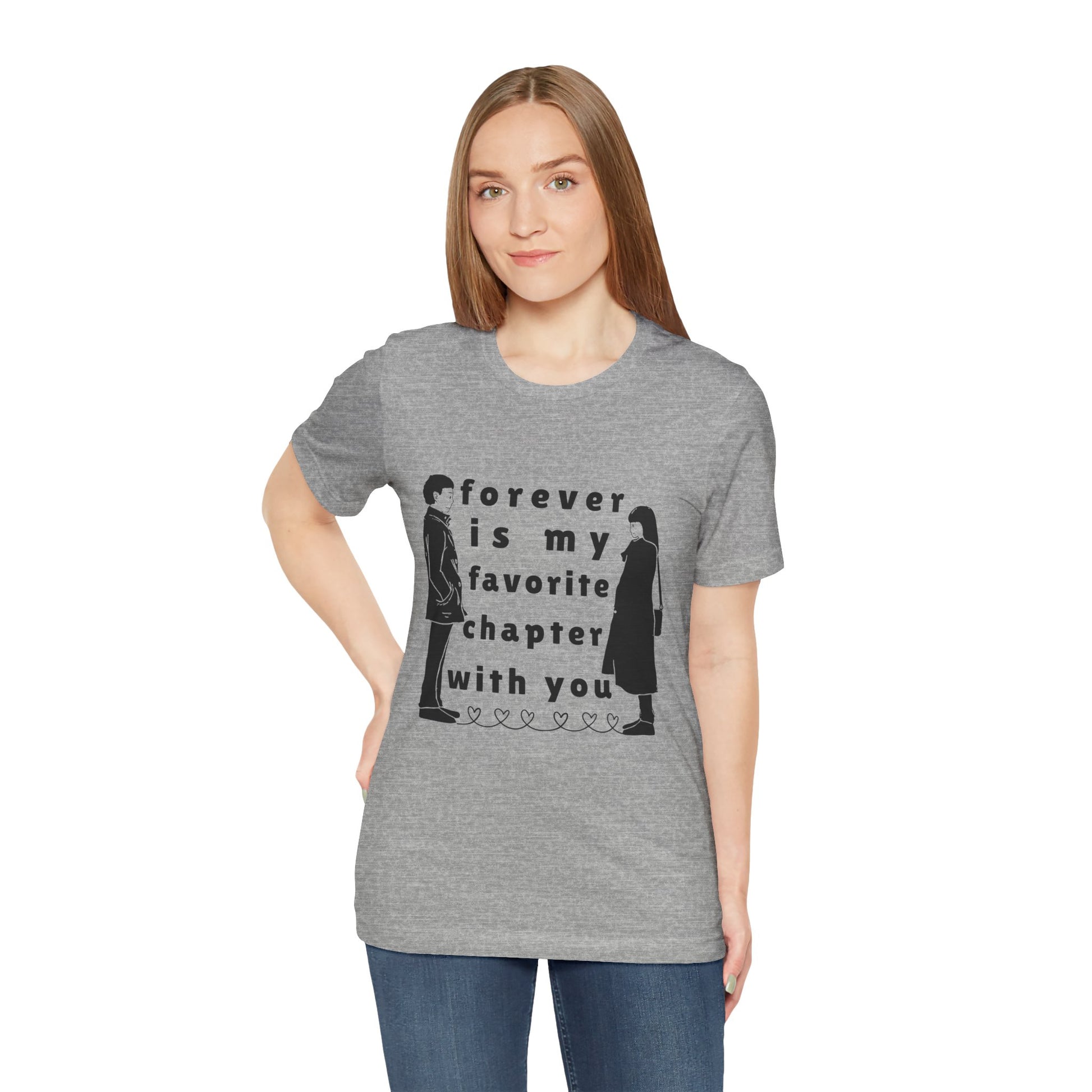 Woman wearing a gray t-shirt with black graphics of a man and woman facing each other and in between is text 'Forever Is My Favorite Chapter With You'