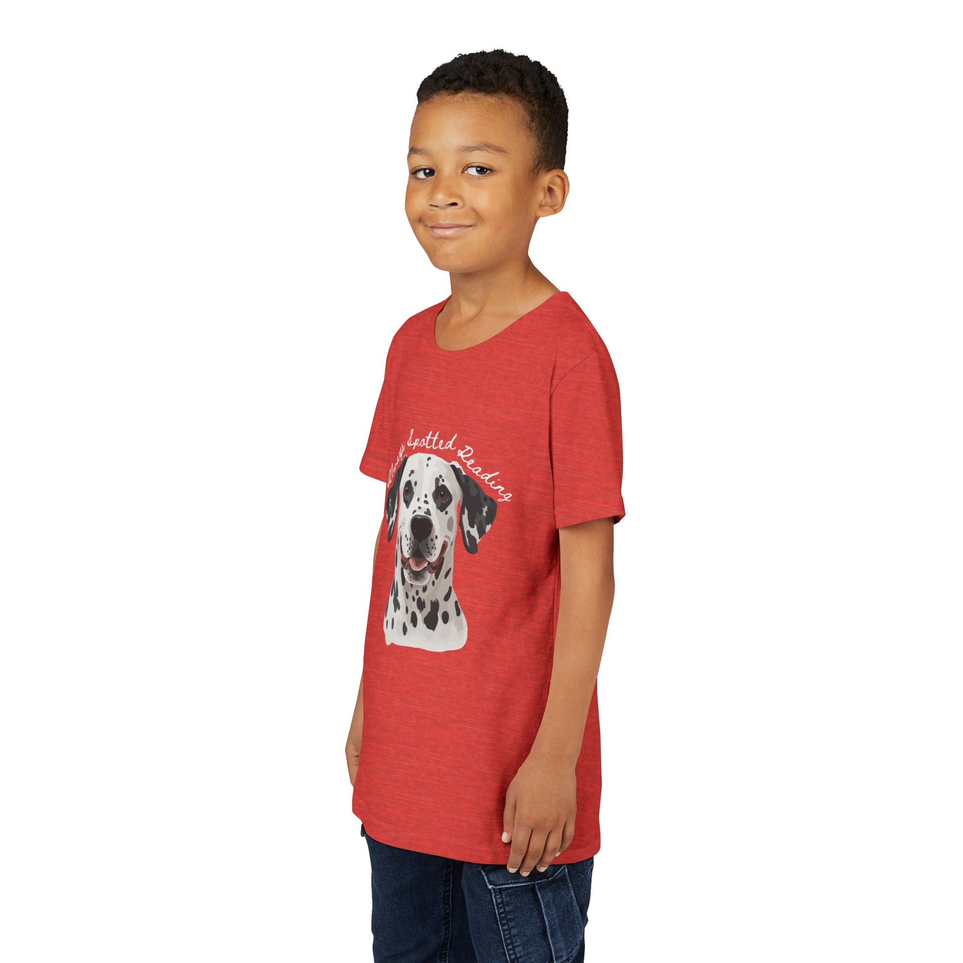 Boy wearing a red t-shirt with a Dalmatian dog graphic and text 'Always Spotted Reading'