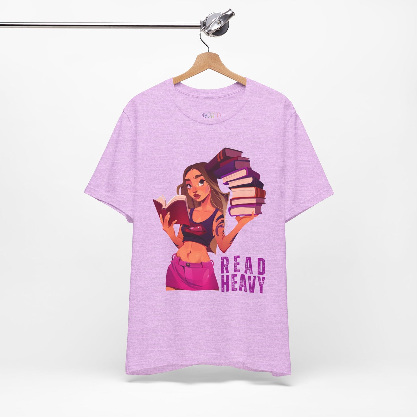 Light purple t-shirt with a stylish woman graphic reading a book in one hand and holding a stack of books in the other, and the text 'Read Heavy' 