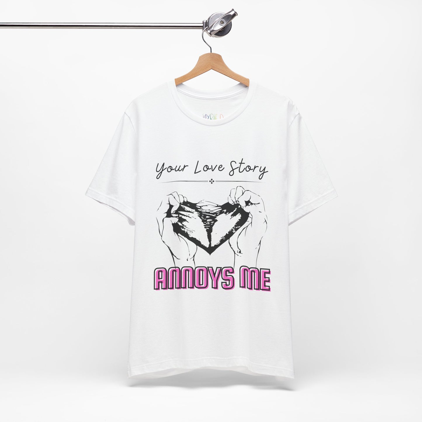 White t-shirt with graphic design of two hands pulling apart a heart and text 'Your Love Story ANNOYS ME'