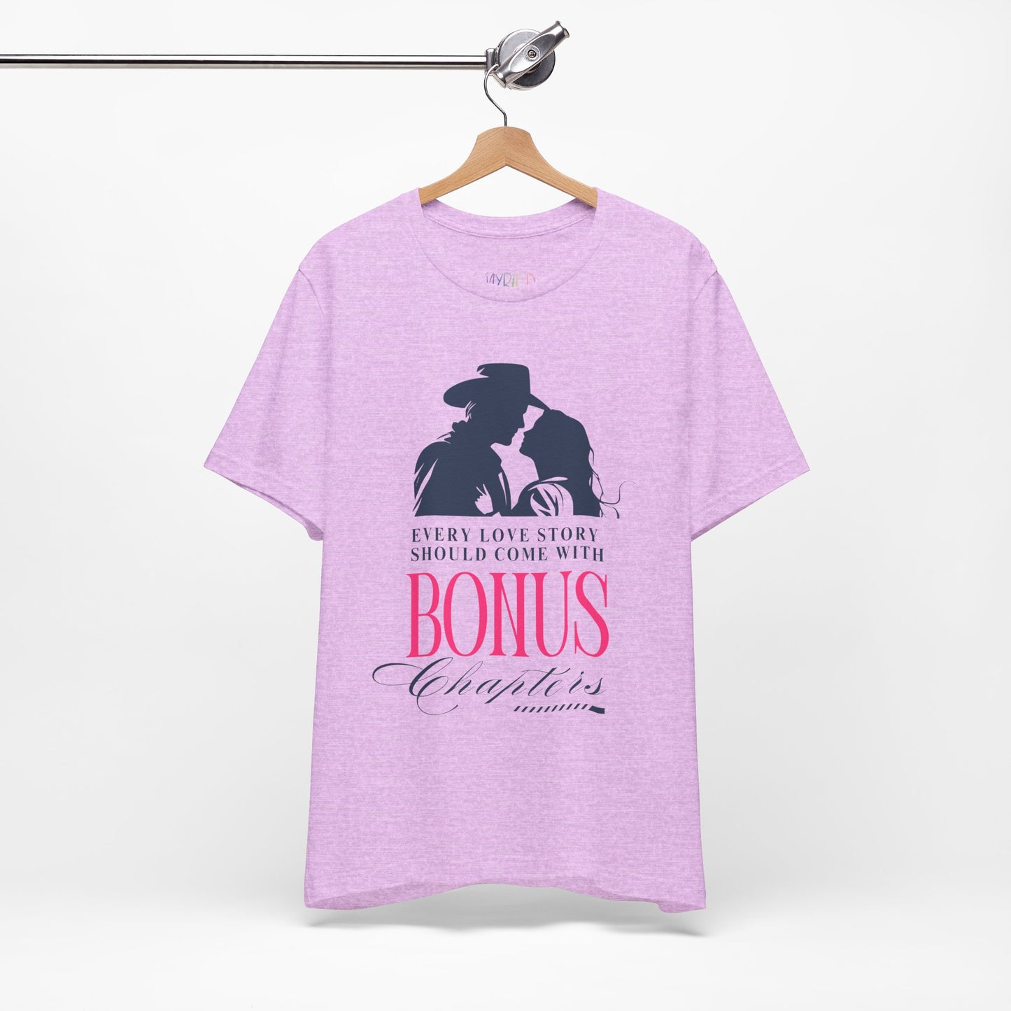 Light purple t-shirt with western graphic of a man and woman leaning in for a kiss, text "Every Love Story Should Come With BONUS Chapters'