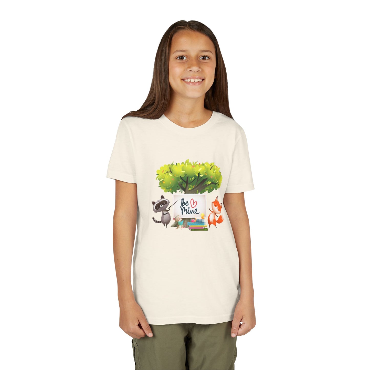 Girl wearing a beige t-shirt with a raccoon and fox graphic and 'Be Mine' text 