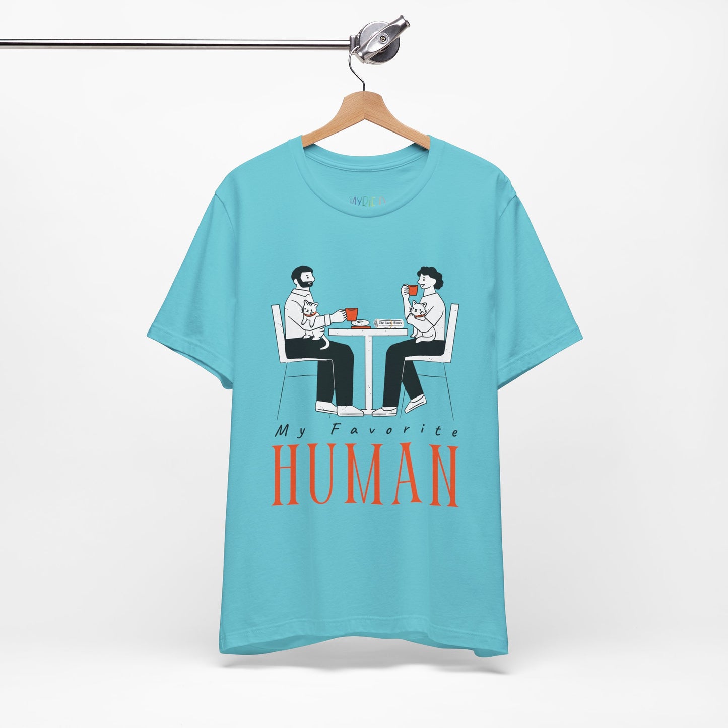 Blue t-shirt with a graphic of two people sitting at a table, newspaper in front of one, drinking hot beverages, holding cats and text 'My Favorite Human' 