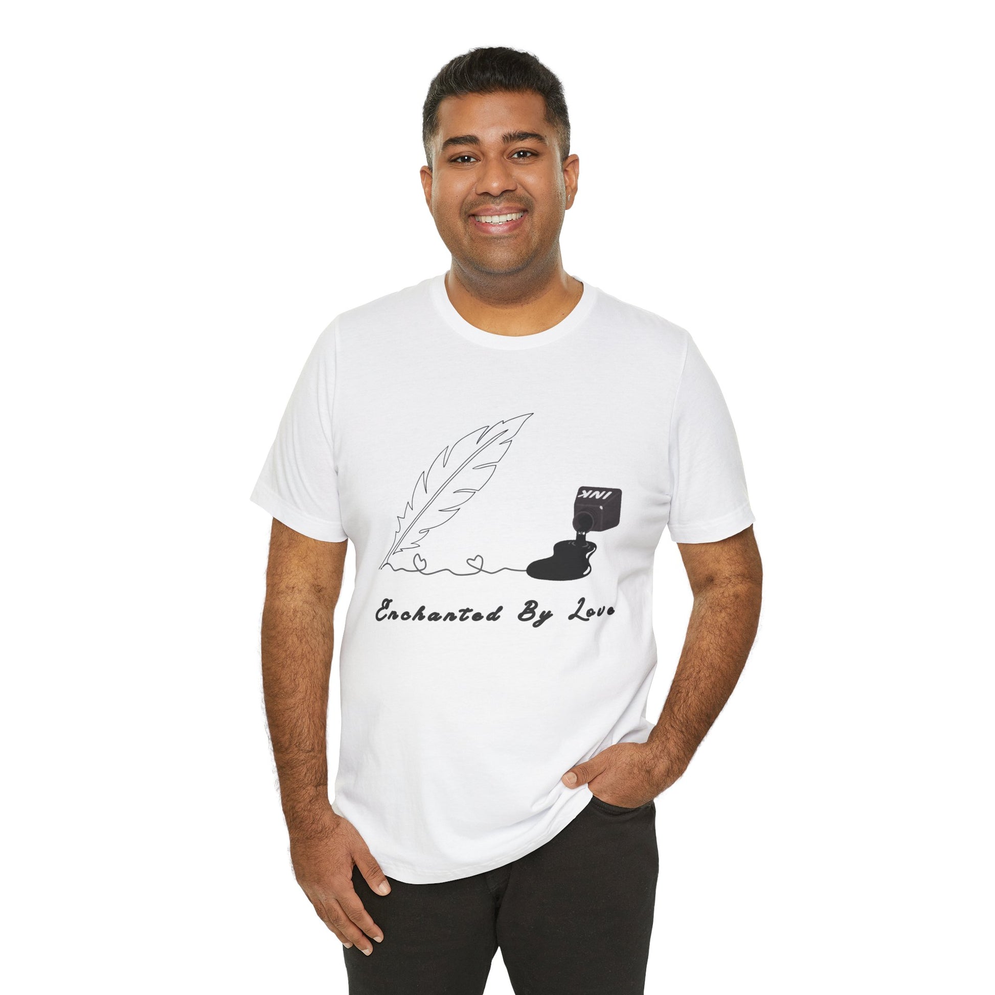 Man wearing a white t-shirt with a black sketched feather quill, spilled ink and text 'Enchanted By Love'