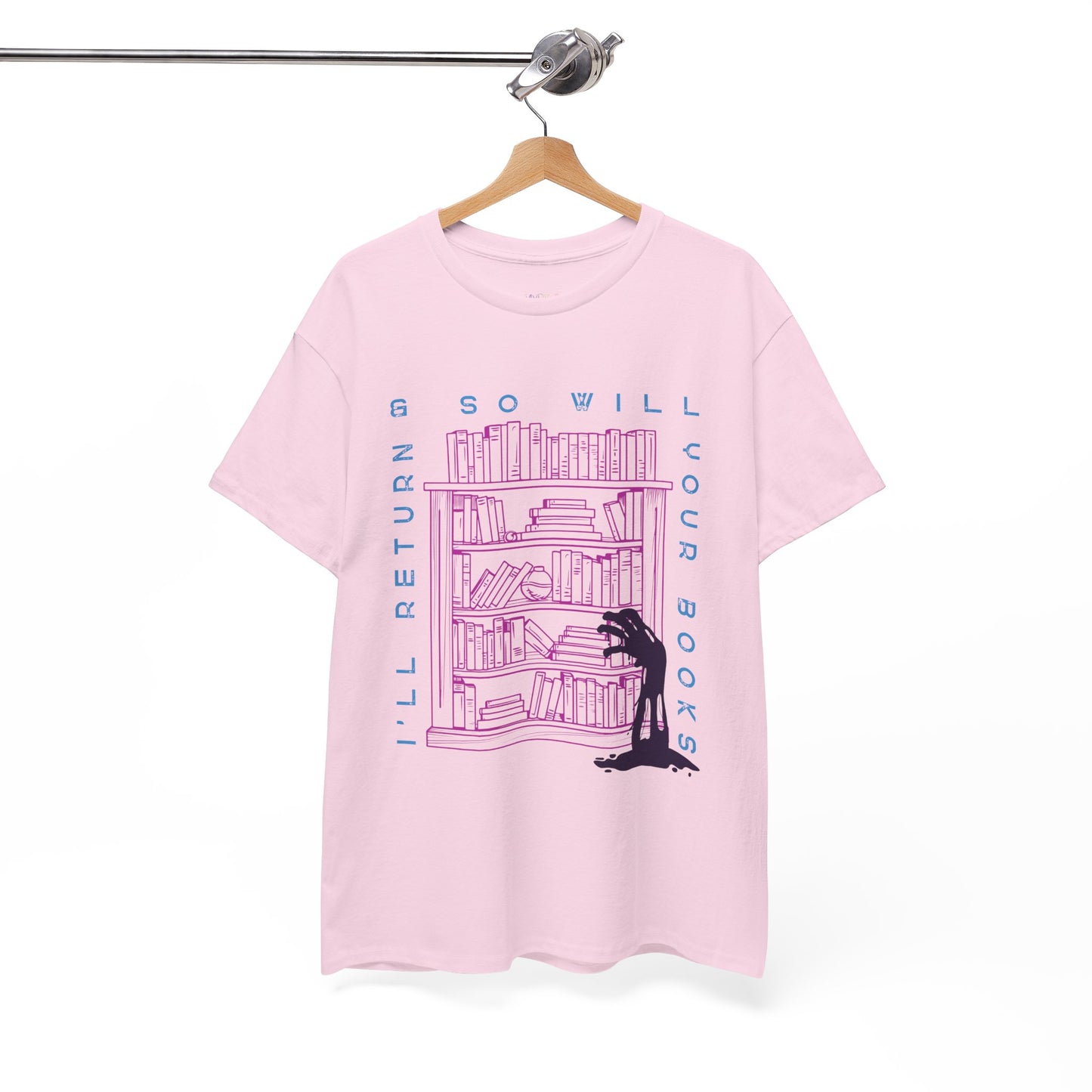 Pink t-shirt with a graphic design of a zombie arm reaching for a book on a bookshelf and text 'I'll Return & So Will Your Books' on a hanger against a white background