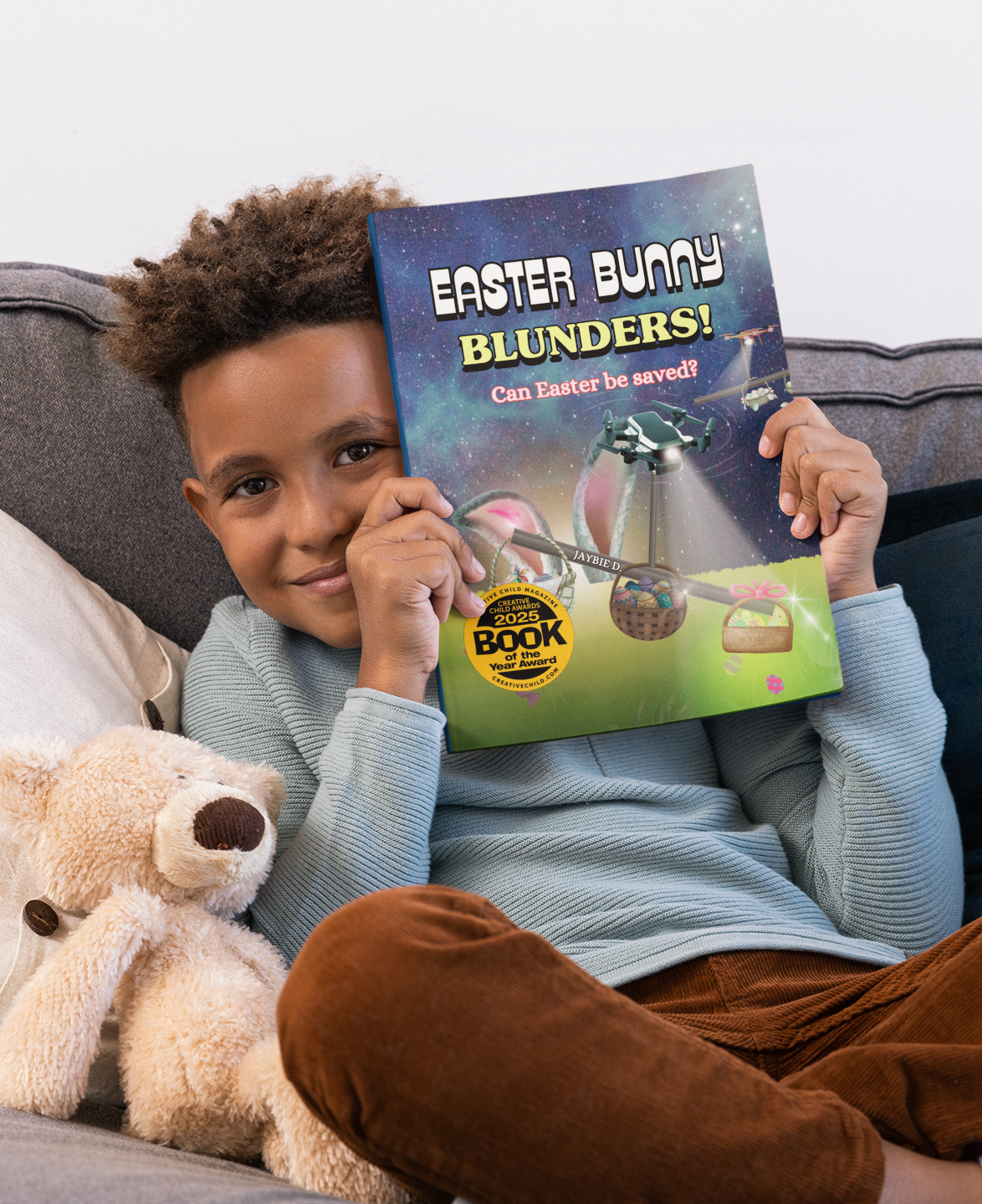 Child holding and reading the Easter Bunny Blunders picture book by Jaybie D featuring Easter bunnies, drones, teamwork, and a fun holiday rescue adventure