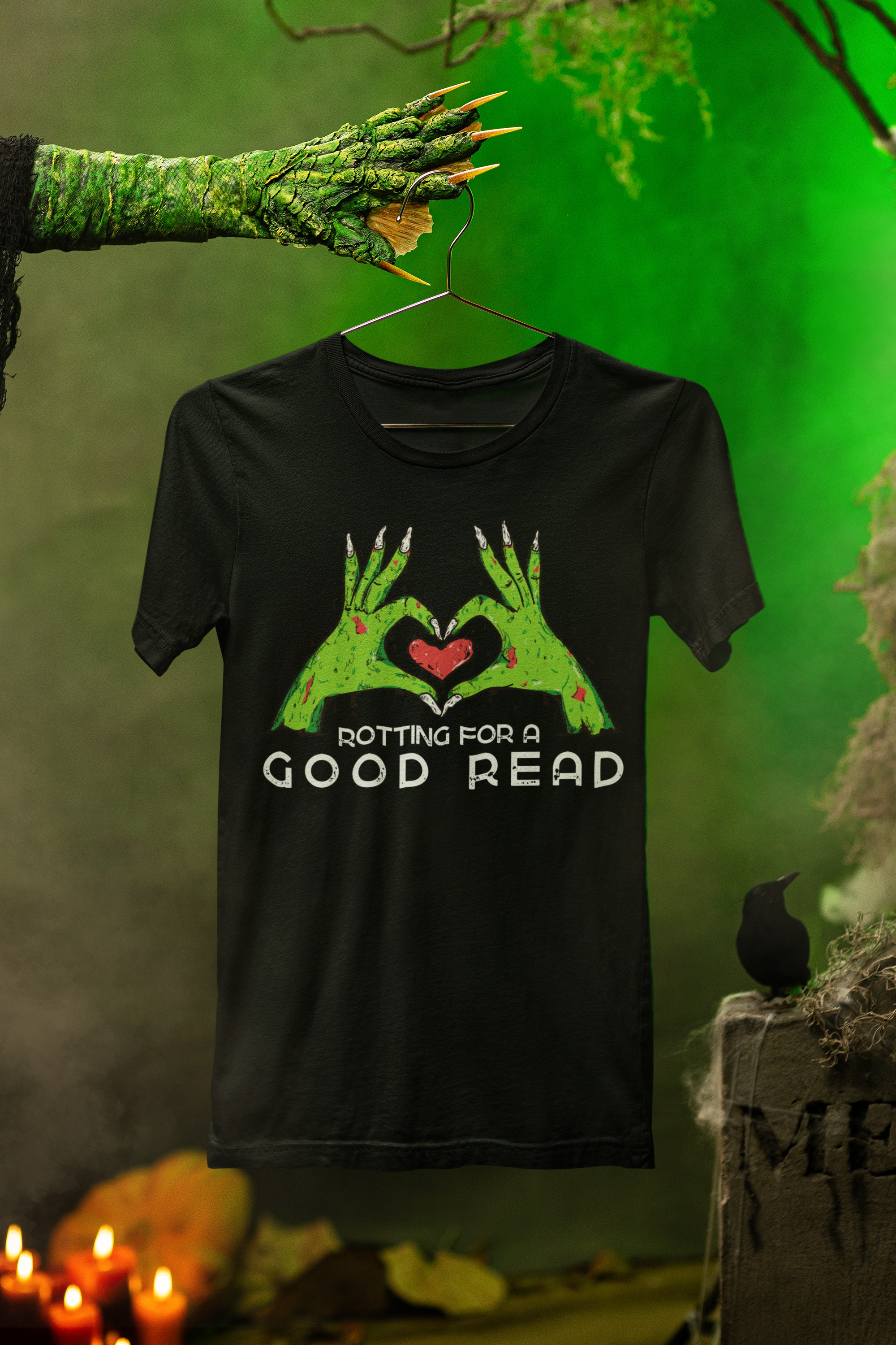 Creepy green monster hand holding a black shirt depicting green zombie hands and the message "rotting for a good read".
