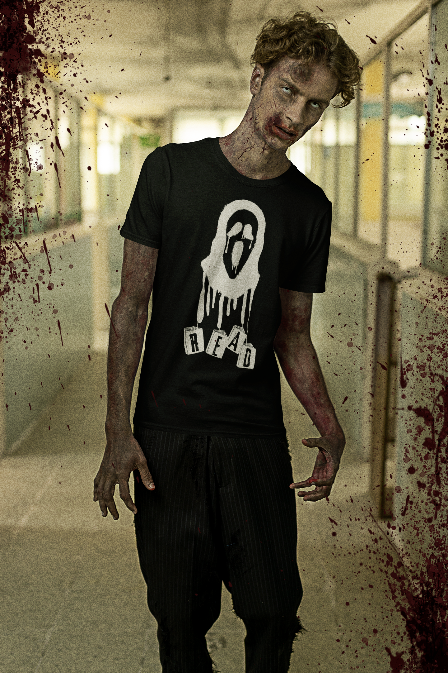 Male zombie in a hallway, wearing a black scream shirt that says READ.