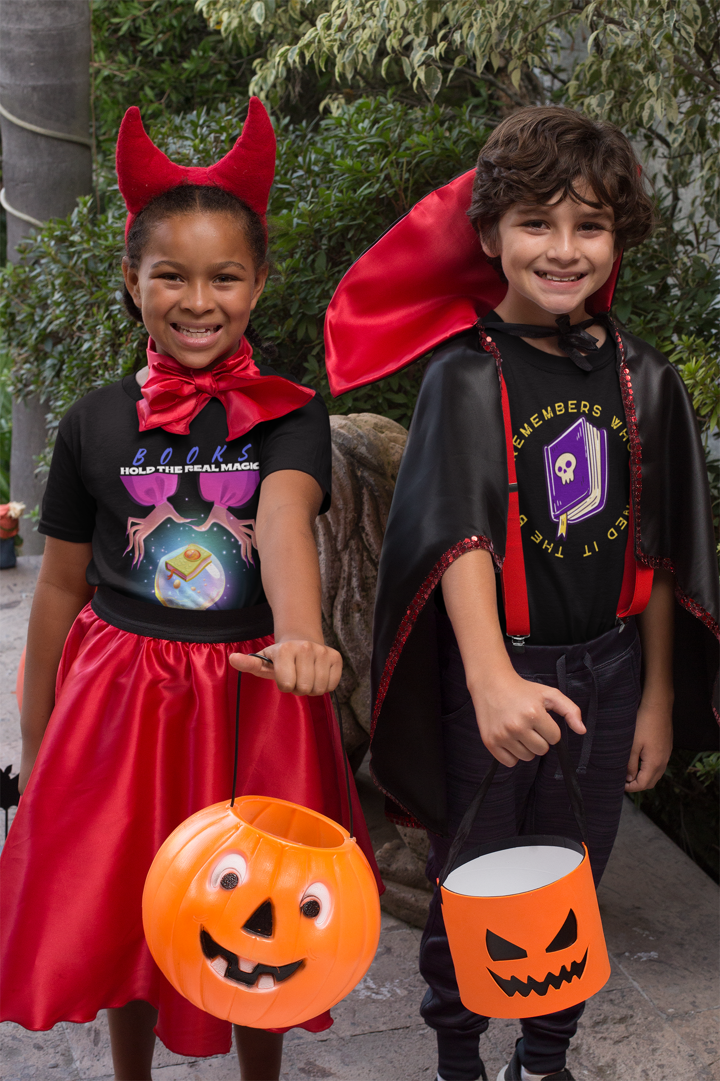 Two kids wearing Halloween shirts and holding trick-or-treat buckets.